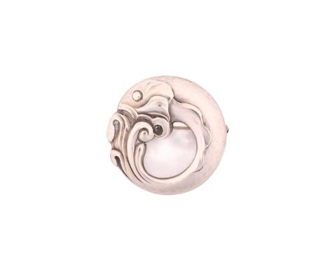 Georg Jensen - A circular fish brooch, depicting a fish coiled in waves, with hinged pin stem and safety catch fittings, No. 
