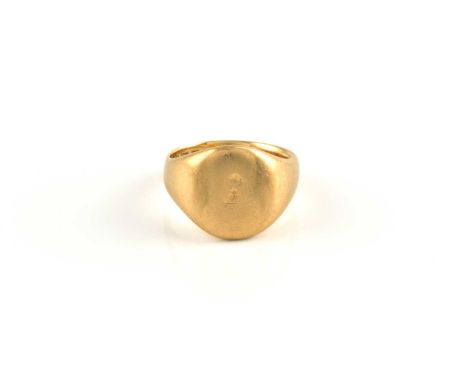 An 18ct gold signet ring, with a minuscule flower engraving on the oval head, to a tapering plain shank, London hallmarked as