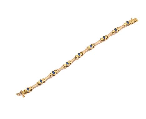 A synthetic blue spinel bar link bracelet, comprises nine oval synthetic blue spinel cabochons, approximately measuring 4.8 x