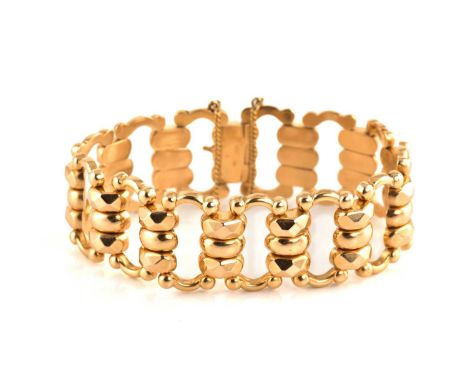 A fancy link bracelet in yellow precious metal, with stylised links adjoined to a tongue and groove clasp, secured with a saf