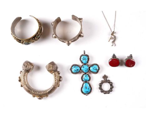 A white metal turquoise set pendant together with two Middle Eastern cuff bangles, another cuff bangle, a pair of earrings, a