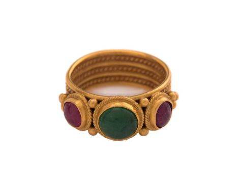 A LALAoUNIS ring with emerald and ruby, consisting of a round emerald cabochon in the centre, flanked by two ruby cabochons, 