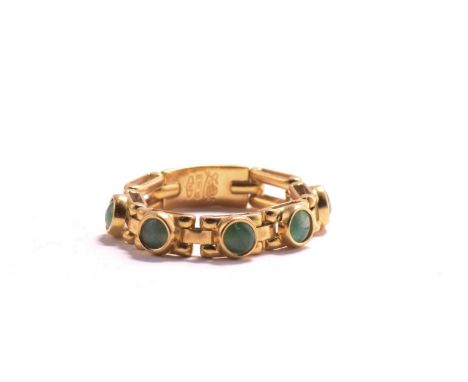 A soft chain ring with emeralds, comprises five emerald cabochons collet set on yellow metal link mounts, hinge connected, It