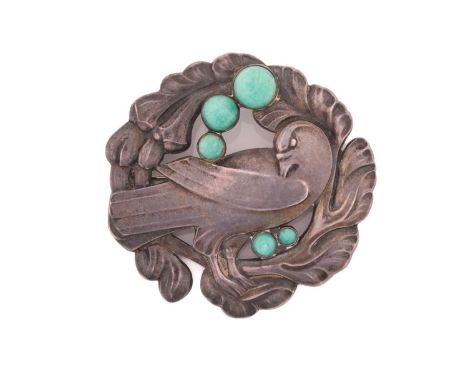 Georg Jensen - An embossed silver brooch, depicting dove in wreath with amazonite cabochon accents, with hinged pin stem and 