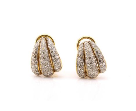 A pair of diamond clip-on earrings, each fully pavé set with brilliant diamonds, on a clam motif mount in yellow precious met