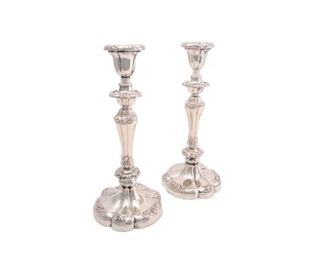 A pair of early 20th century loaded silver table candlesticks with segmental bodies and on spreading lobed bases. 33.5 cm hig