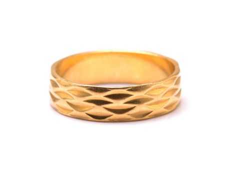 A 22ct yellow gold wedding ring, with geometric pattern carved throughout the band, engraved '1974' inside the shank, London 