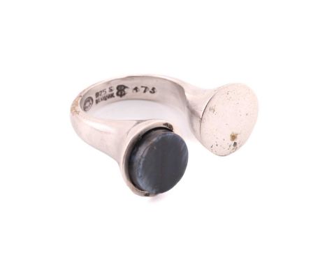 Georg Jensen - A dress ring with polished hawk's eye, comprises an open shank with a flat round panel end, the other a round 