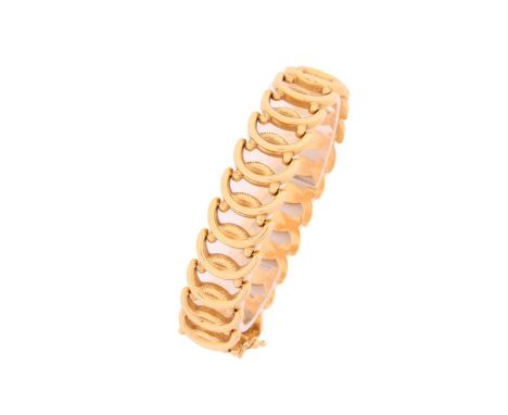 A wide fancy link bracelet, with textured oval interlocking links in yellow precious metal, fastened with a discrete tongue a