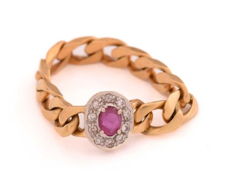 A soft chain ring with ruby and diamonds, ring head comprises an oval ruby encircled with diamond accents, attached to a curb