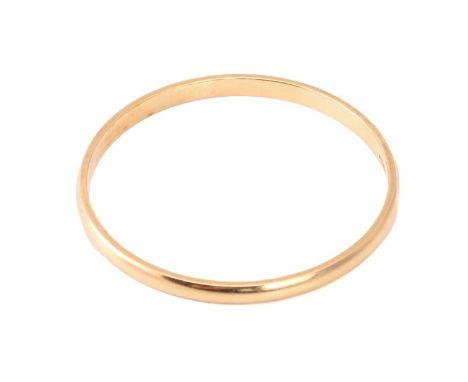 A yellow precious metal closed bangle, with a solid D-profile band, marked as '18ct OBLO', inner circumference approximately 