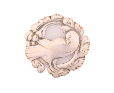 Georg Jensen - An embossed silver brooch, depicting dove in wreath, with hinged pin stem and safety catch fittings, dove moti