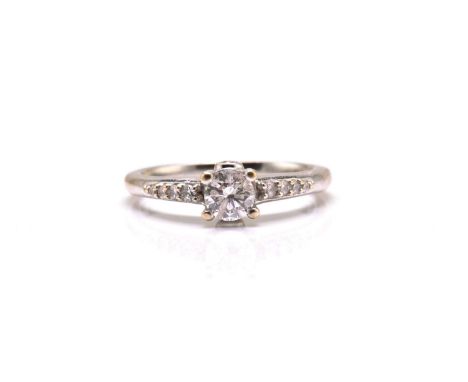 An 18ct white gold diamond solitaire ring, comprises a brilliant diamond with an estimated weight of 0.38ct, claw set on a lo