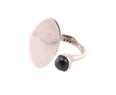 Georg Jensen - a Modernist ring with spectrolite, comprises an open shank with a flat oval panel end, the other a round spect