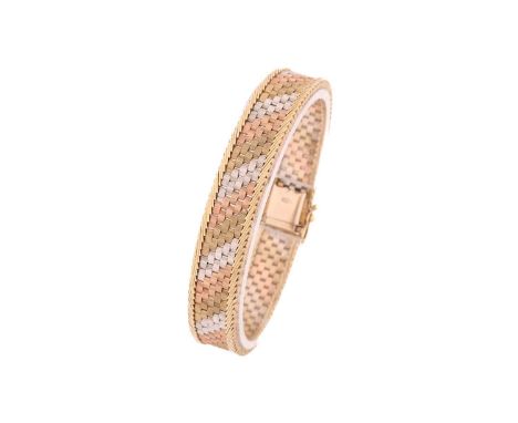A 9ct three-tone gold brick link bracelet, edged with snake links, fastened with a tongue and groove clasp and a figure of ei