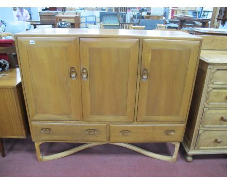 Ercol Ash Cabinet, with three cupboard doors over two drawers on a X stretcher base, 129cm wide.Lot 1595 - has two internal d