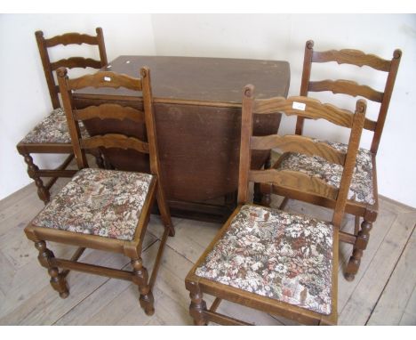 Oak drop leaf gate leg table on turned supports and a set of four ladder back chairs with drop-in upholstered seats 