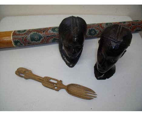 Two carved hard wood African style bust figures, a didgeridoo and a carved African style salad server (4) 