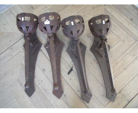 Four heavy wrought metal Baronial style wall light brackets (length 65cm) 