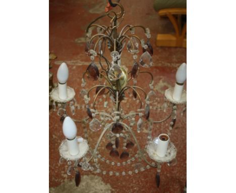A Victorian cast metal standard oil lamp and a small chandelier with purple coloured drops