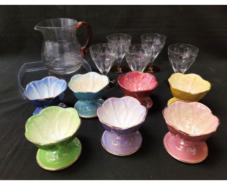 SEVEN COLOURFUL MALING SUNDAE DISHESwith a vintage glass pitcher, with amber glass handle and floral etching to edge and five