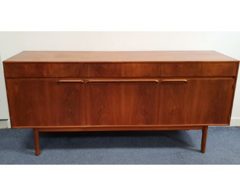 MID CENTURY TEAK SIDEBOARD BY MCINTOSH with three concealed drawers the left hand being a felt lined cutlery drawer, above th