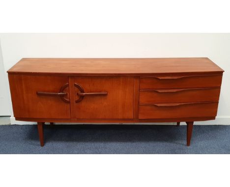 MID CENTURY BOW FRONTED TEAK SIDEBOARD BY BEAUTILITY with three drawers to the right, the top being a partially felt lined cu