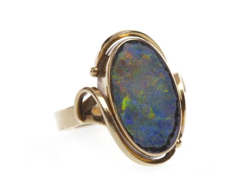 ART NOUVEAU STYLE BLACK OPAL DRESS RINGset with an oval section of opal 16x9mm, on ornate shoulders, in nine carat gold, size