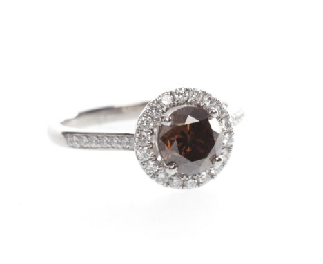 PLATINUM COGNAC DIAMOND CLUSTER RINGwith a central round brilliant cut diamond with cognac tones approximately 1.11 carats su