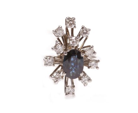 1960S SAPPHIRE AND DIAMOND CLUSTER RINGthe spray bezel set with a single central oval sapphire 8.1x5.6mm with blue-green tone