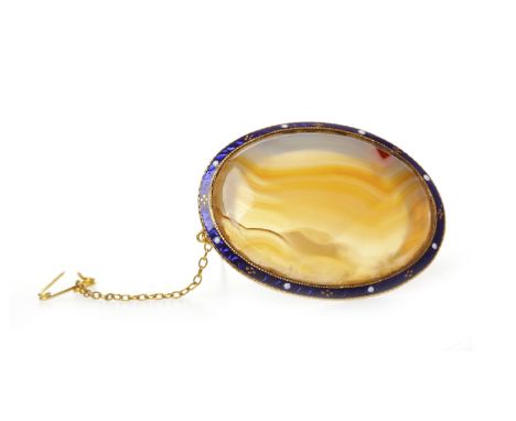 LATE VICTORIAN HARDSTONE AND ENAMEL BROOCHset with a large oval section of banded agate with orange tones, 40mm long, within 