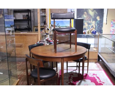 A vintage G-Plan extending round table and four chairs. Table is 122cm diameter and chairs are 76cm tall postage unavailable.