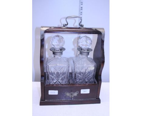A vintage two decanter Tantalus with key 