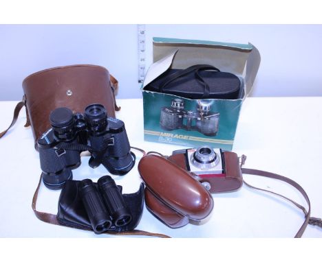Three pairs of vintage binoculars and a vintage Kodak camera 