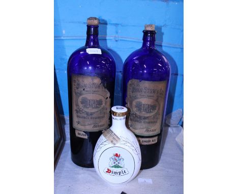 Two antique blue bottles by John Stow &amp; Co (liquid still present), along with a empty Dimples scotch whiskey bottle comme