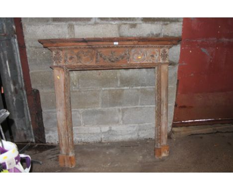 A carved pine fire surround 