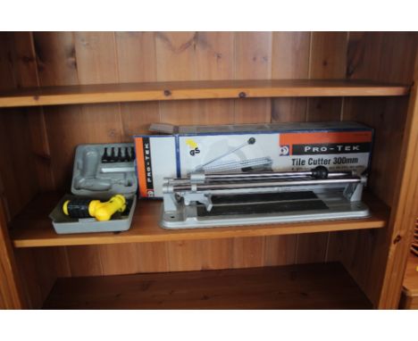A tile cutter together with a screwdriver 