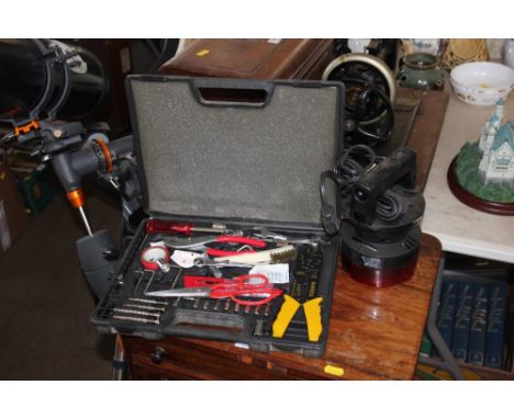 A case of various tools; together with a car light