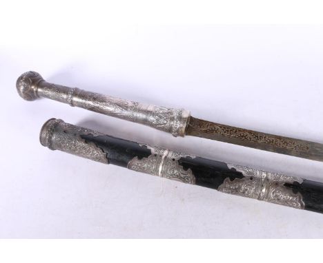 Burmese dha / Thai daab type sword, the 59cm long blade with engraved scroll band, the handle with repousse designs of flower