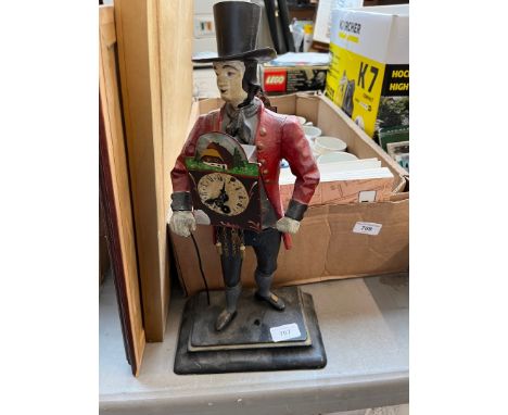 A reproduction figural clock modelled as a gentleman in period costume with clocks mounted to chest and back, height 40cm. 