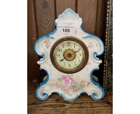 An ornate porcelain mantel clock. 