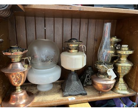 A group of 6 oil / paraphin lamps to include an Arts and Crafts copper lamp - no funnel and no shade, a Victorian twin burner