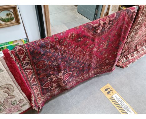 A vintage eastern hand knotted wool carpet, red ground, 250cm x 170cm. 