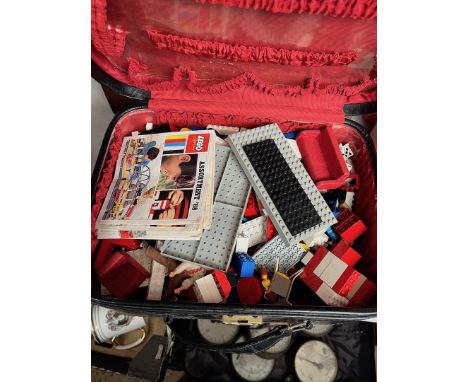 A vintage case containing mostly lego and some vintage toys. 