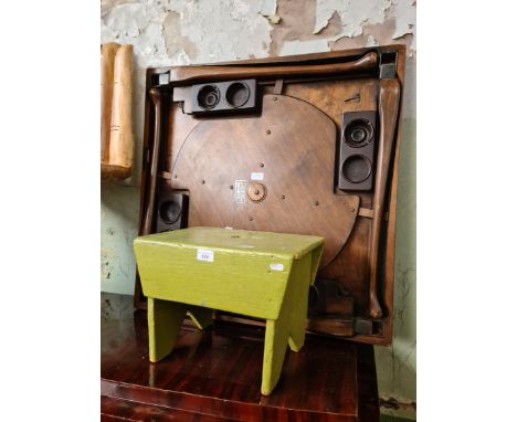 A green painted stool and a folding card table. 