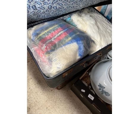 A vintage suitcase containing quantity of vintage clothing including furs and another vintage suitcase and a small briefcase.