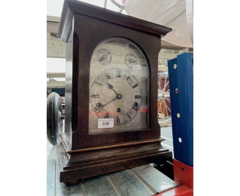 An early 20th century German chiming clock, with pendulum and keys. 