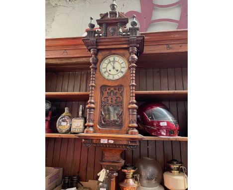 A walnut cased spring driven Vienna wall clock, length 111cm.Dimensions:- Maximum width is 40cm