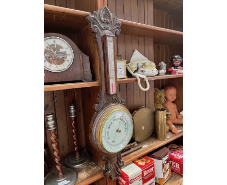 A wooden case barometer with thermometer 