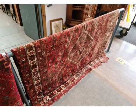 A vintage eastern hand knotted wool carpet, red ground, 196cm x 160cm (approx). 